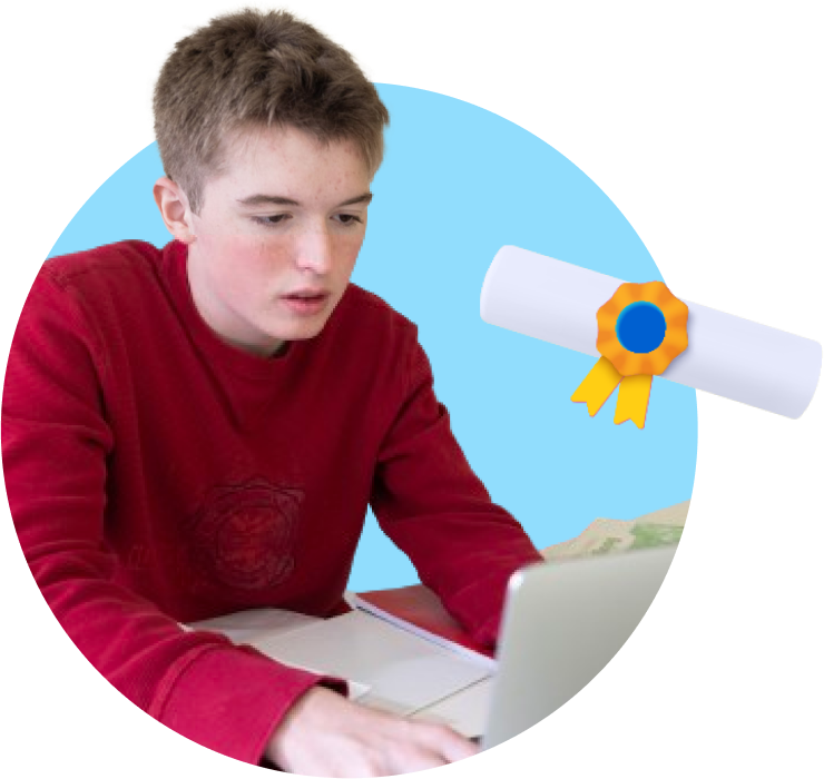 a boy sitting at a desk with a laptop